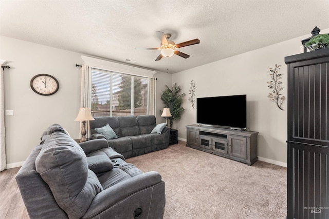 3065 E Ionia Ct, Meridian, ID 83642 - living area with ceiling fan, a textured ceiling, baseboards, and carpet