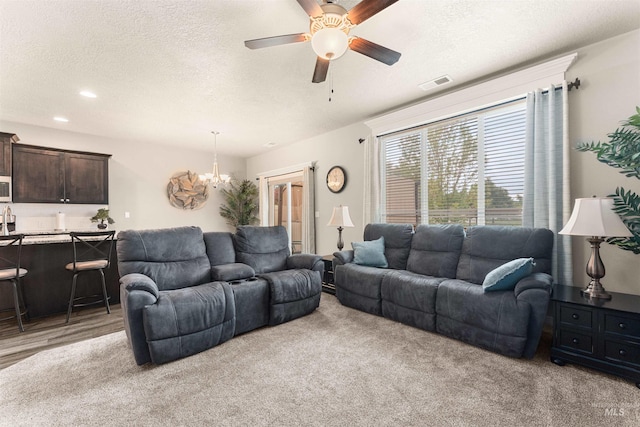 3065 E Ionia Ct, Meridian, ID 83642 - living room with a chandelier, a ceiling fan, a textured ceiling, light carpet, and recessed lighting