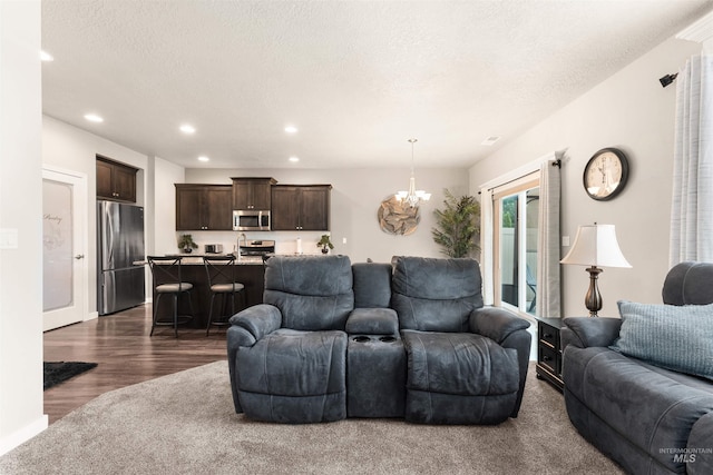 3065 E Ionia Ct, Meridian, ID 83642 - living room with a chandelier, recessed lighting, dark wood-style floors, a textured ceiling, and baseboards