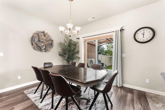 3065 E Ionia Ct, Meridian, ID 83642 - dining space with a chandelier, baseboards, and dark wood-style floors