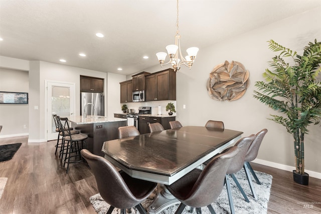 3065 E Ionia Ct, Meridian, ID 83642 - dining space with a chandelier, recessed lighting, dark wood-style flooring, and baseboards