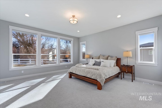 bedroom featuring multiple windows and baseboards