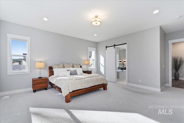 carpeted bedroom featuring a barn door, multiple windows, baseboards, and recessed lighting