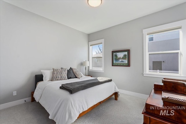 bedroom with carpet flooring and baseboards