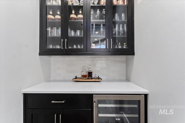 bar with tasteful backsplash, wine cooler, and a dry bar