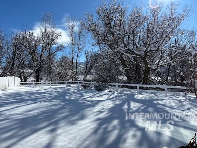 snowy yard with fence