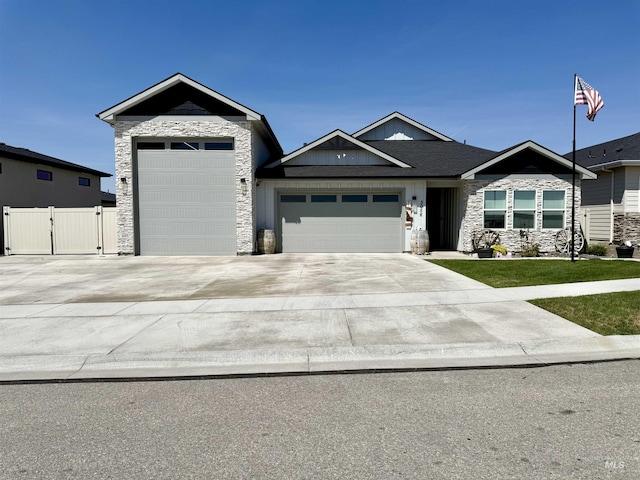 3056 E Columbus River Ct, Nampa, ID 83686 - view of front of home with a garage, a gate, stone siding, and concrete driveway