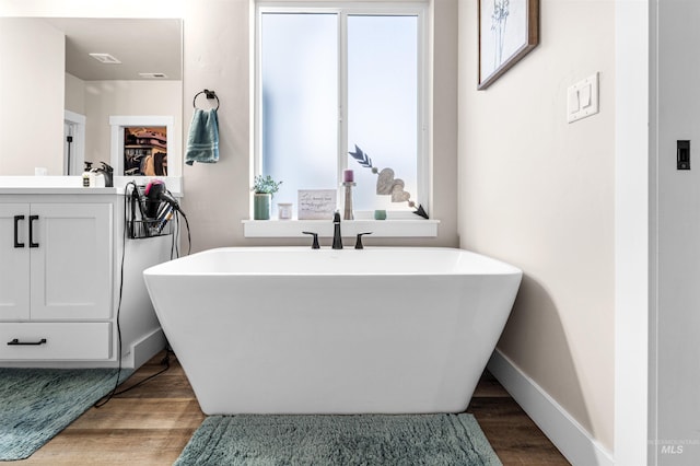 3056 E Columbus River Ct, Nampa, ID 83686 - full bath with plenty of natural light, wood finished floors, and a soaking tub