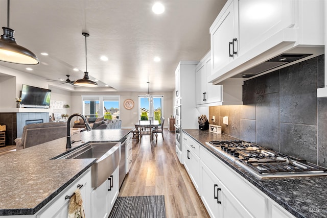 3056 E Columbus River Ct, Nampa, ID 83686 - kitchen with ceiling fan, recessed lighting, a tile fireplace, light wood-style flooring, and stainless steel appliances