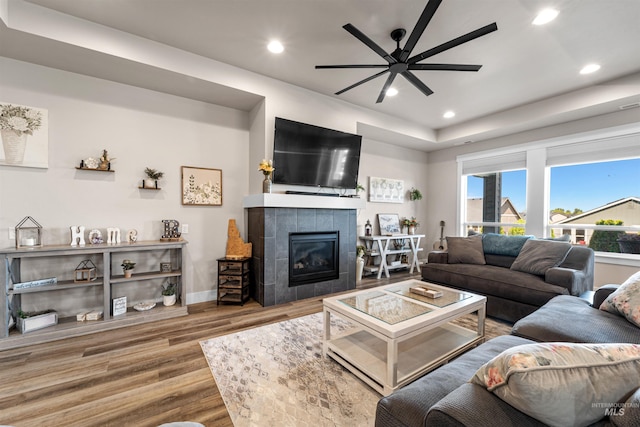 3056 E Columbus River Ct, Nampa, ID 83686 - living room featuring recessed lighting, ceiling fan, a tiled fireplace, and wood finished floors