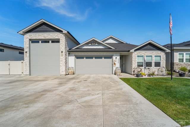 3056 E Columbus River Ct, Nampa, ID 83686 - view of front of property with driveway, a gate, a garage, a front lawn, and stone siding