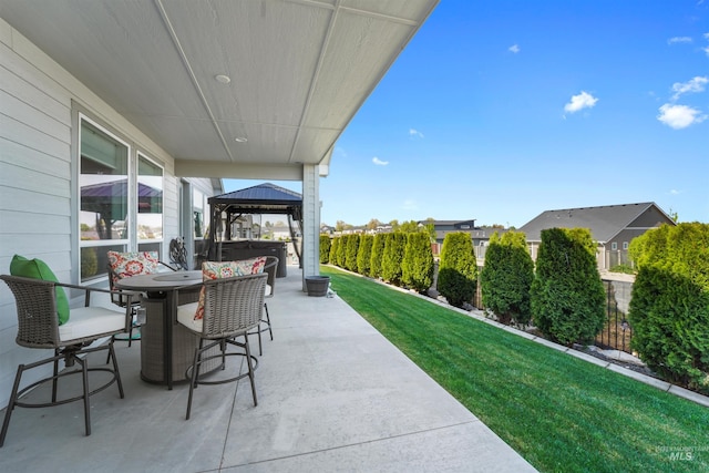 3056 E Columbus River Ct, Nampa, ID 83686 - view of patio featuring a gazebo, outdoor dining area, a hot tub, and fence private yard