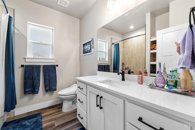 3056 E Columbus River Ct, Nampa, ID 83686 - full bathroom featuring visible vents, wood finished floors, baseboards, vanity, and toilet