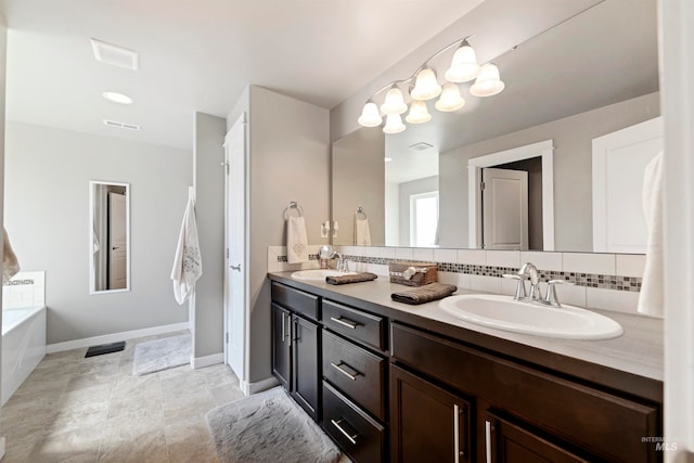 bathroom featuring a washtub, decorative backsplash, dual vanity, and tile patterned floors