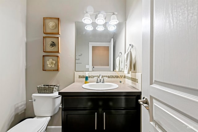 bathroom with toilet and vanity