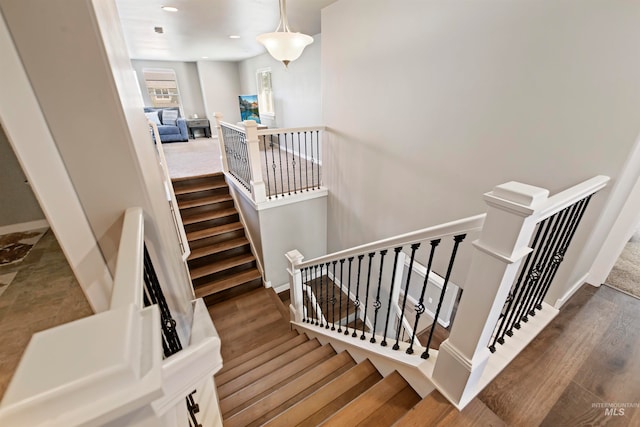 stairs with hardwood / wood-style floors