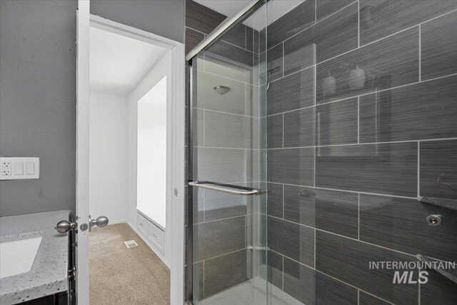 2702 N Camden Pl, Boise, ID 83704 - bathroom with a shower stall, baseboards, a sink, and visible vents