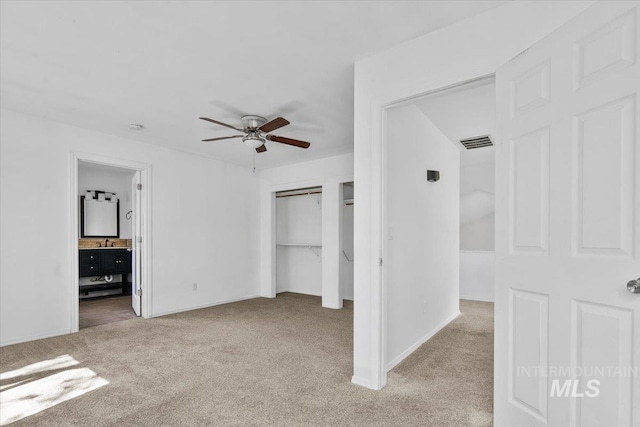 2702 N Camden Pl, Boise, ID 83704 - unfurnished bedroom featuring a closet, connected bathroom, carpet floors, baseboards, and visible vents