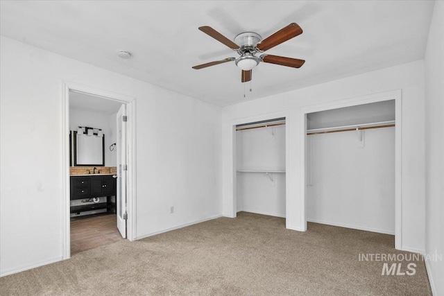 2702 N Camden Pl, Boise, ID 83704 - unfurnished bedroom featuring carpet, a ceiling fan, connected bathroom, baseboards, and two closets