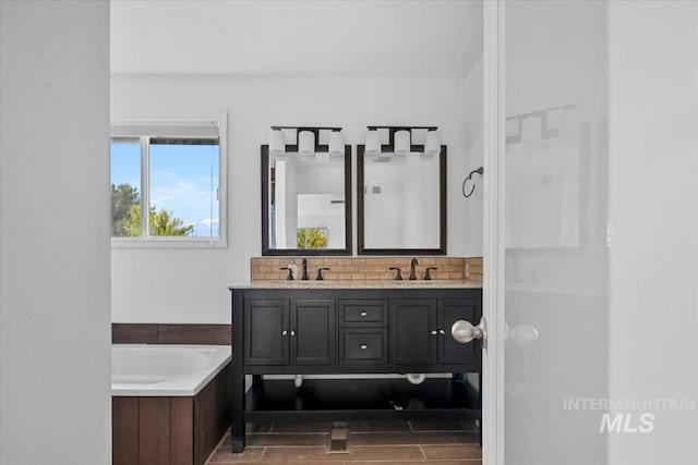 2702 N Camden Pl, Boise, ID 83704 - full bathroom featuring a bath, wood finished floors, a sink, and double vanity