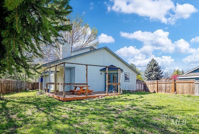 2702 N Camden Pl, Boise, ID 83704 - rear view of property featuring a fenced backyard, a wooden deck, a chimney, and a yard
