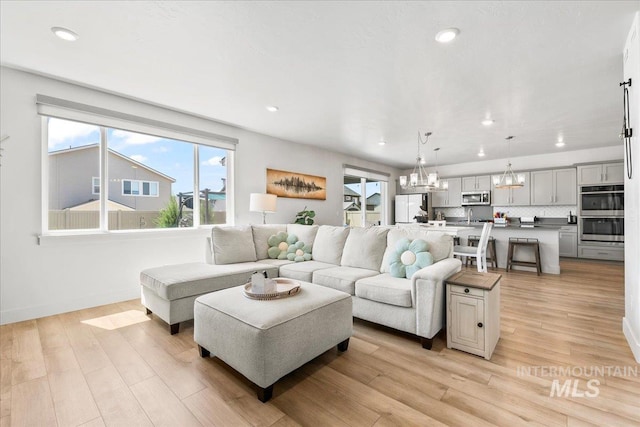 11211 Sopris Loop, Caldwell, ID 83605 - living area with a chandelier, recessed lighting, light wood-style floors, and baseboards