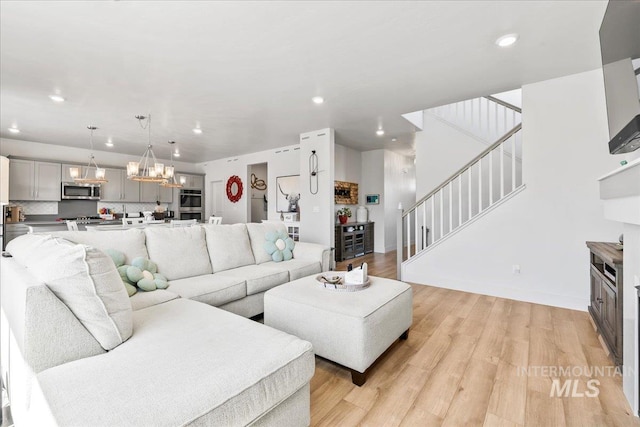 11211 Sopris Loop, Caldwell, ID 83605 - living area with stairs, recessed lighting, a chandelier, light wood-type flooring, and baseboards