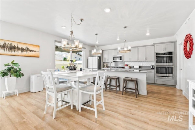11211 Sopris Loop, Caldwell, ID 83605 - dining area with a chandelier, light wood-type flooring, and recessed lighting