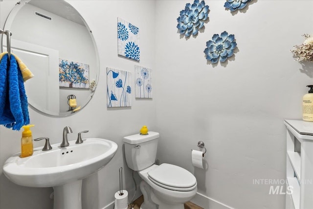 11211 Sopris Loop, Caldwell, ID 83605 - bathroom with toilet, a sink, and baseboards