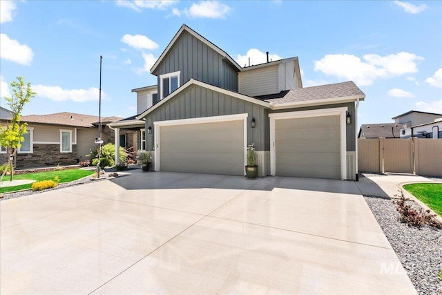 11211 Sopris Loop, Caldwell, ID 83605 - view of front of home with board and batten siding, an attached garage, concrete driveway, fence, and a gate