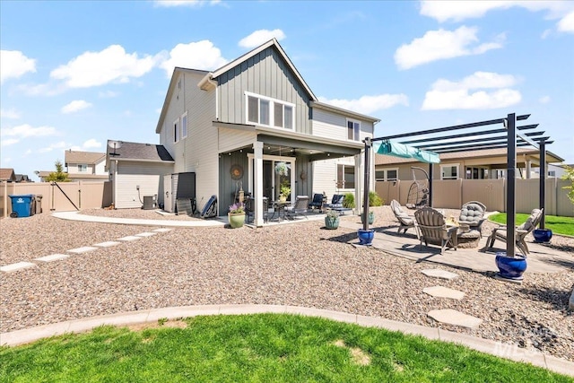 11211 Sopris Loop, Caldwell, ID 83605 - rear view of property with board and batten siding, a pergola, a patio area, a fenced backyard, and ceiling fan
