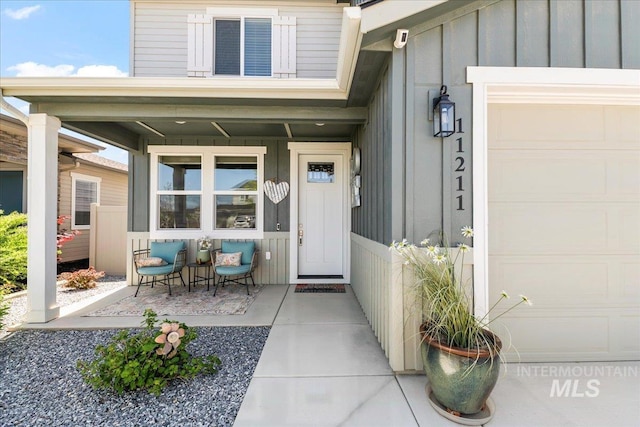 11211 Sopris Loop, Caldwell, ID 83605 - view of exterior entry featuring covered porch, board and batten siding, and an attached garage