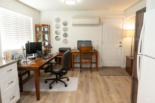 office space with light hardwood / wood-style floors and an AC wall unit