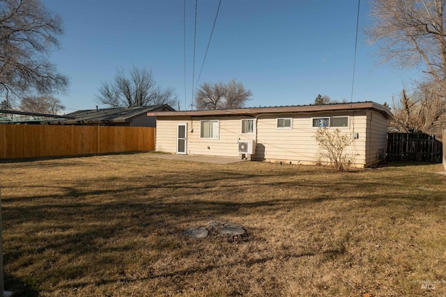 back of house with a yard and a patio