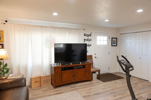 interior space with light hardwood / wood-style flooring and a textured ceiling