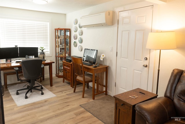 office area featuring a wall mounted AC and light hardwood / wood-style floors