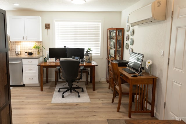 office space featuring a wall mounted air conditioner and light hardwood / wood-style flooring