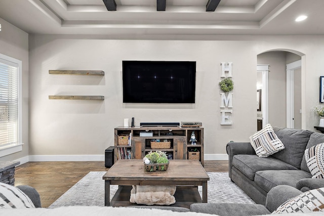 living room with baseboards, arched walkways, wood finished floors, and recessed lighting