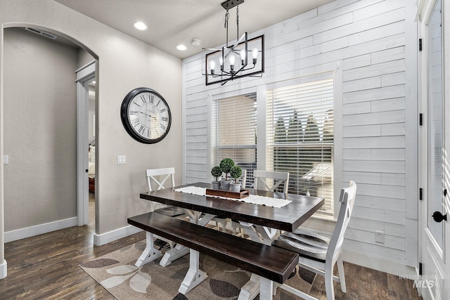 dining room featuring a notable chandelier, dark wood finished floors, visible vents, and baseboards