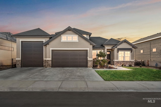 view of front of home with a garage, stone siding, concrete driveway, and stucco siding