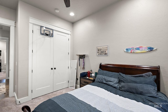 carpeted bedroom with a ceiling fan, a closet, and recessed lighting