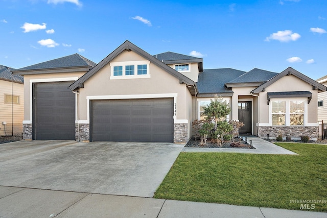 view of front facade featuring an attached garage, stone siding, driveway, stucco siding, and a front lawn