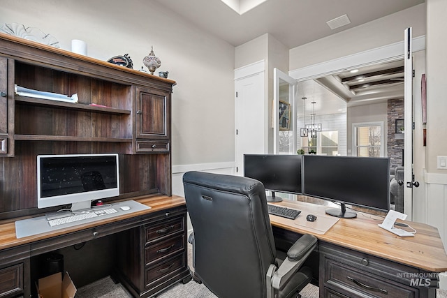 office space with a wainscoted wall and visible vents