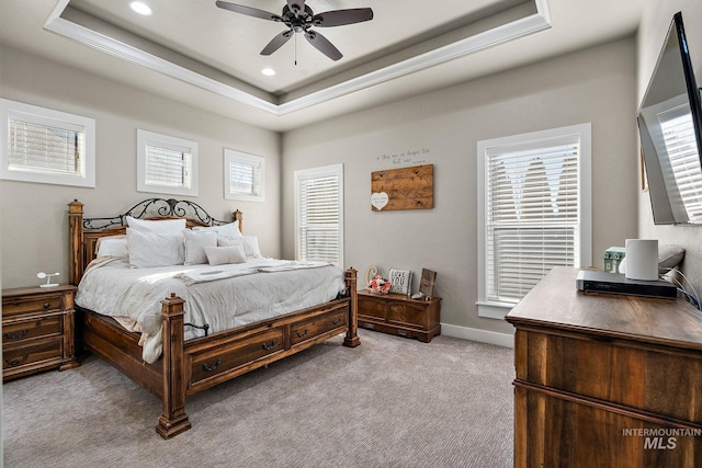 carpeted bedroom with recessed lighting, a raised ceiling, a ceiling fan, and baseboards