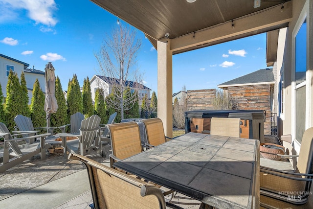 view of patio featuring outdoor dining space and a hot tub