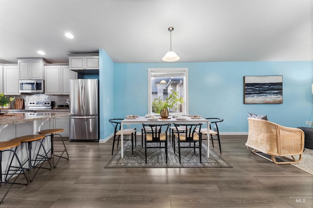 dining space featuring dark wood-type flooring