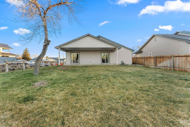 rear view of property with a yard