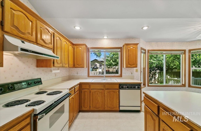 900 N Player Ave, Eagle, ID 83616 - kitchen featuring white appliances, under cabinet range hood, wallpapered walls, a sink, and light countertops