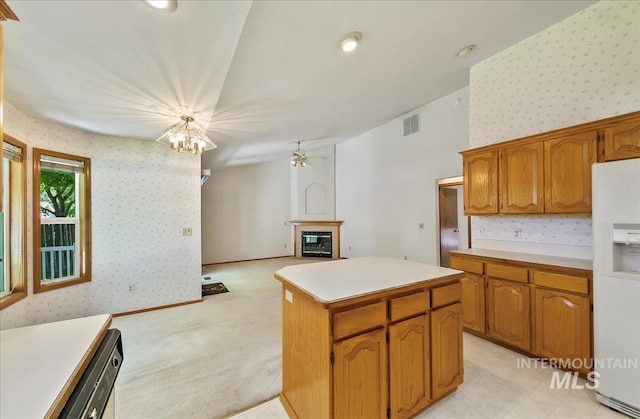 900 N Player Ave, Eagle, ID 83616 - kitchen featuring white fridge with ice dispenser, wallpapered walls, ceiling fan, a glass covered fireplace, and light countertops