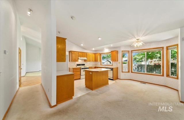 900 N Player Ave, Eagle, ID 83616 - kitchen featuring white range with electric stovetop, dishwasher, light colored carpet, a center island, and wallpapered walls